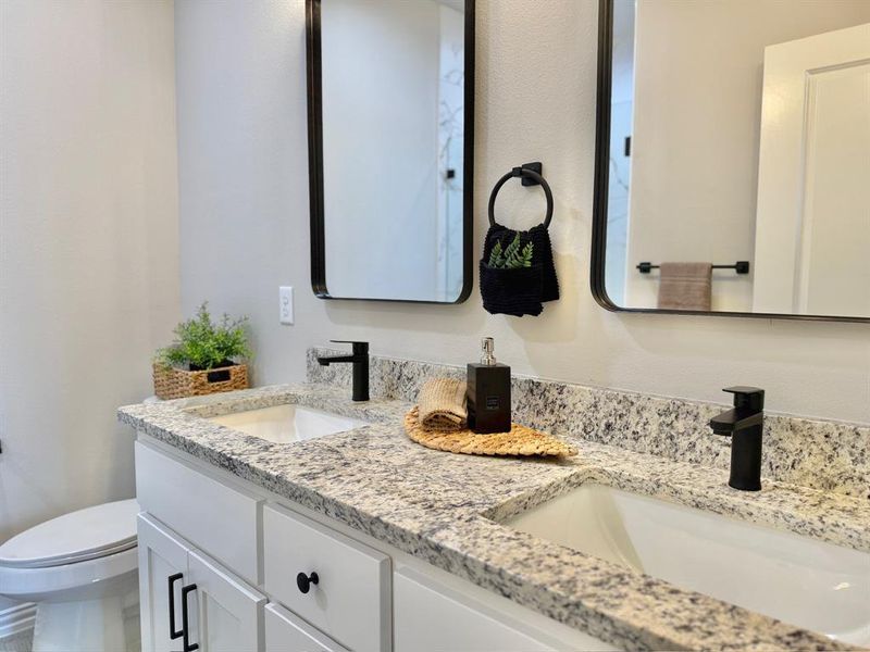 Bathroom featuring vanity and toilet