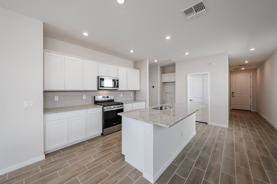 A kitchen with white cabinets. A kitchen with white cabinets.