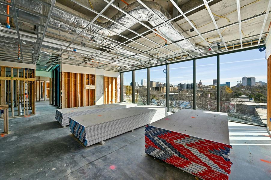 Misc room featuring a city view and unfinished concrete flooring