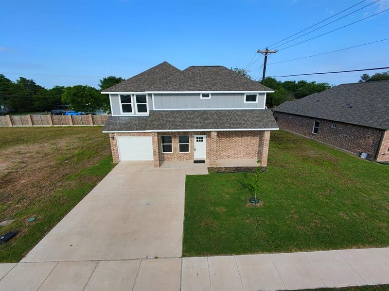 View of front of property featuring brick siding, driveway, a garage, and a shingled roof View of front of property featuring brick siding, driveway, a garage, and a shingled roof