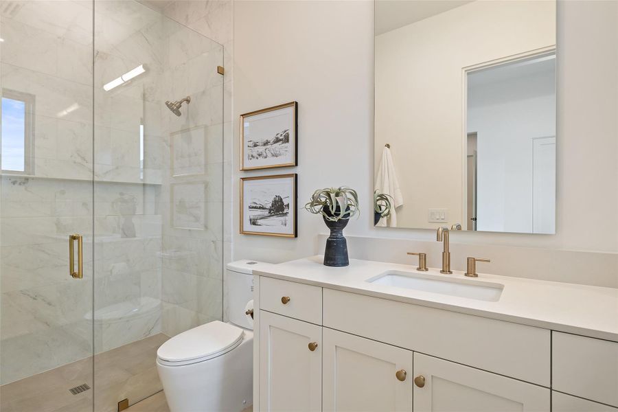 Bathroom with vanity, a shower stall, and toilet Bathroom with vanity, a shower stall, and toilet