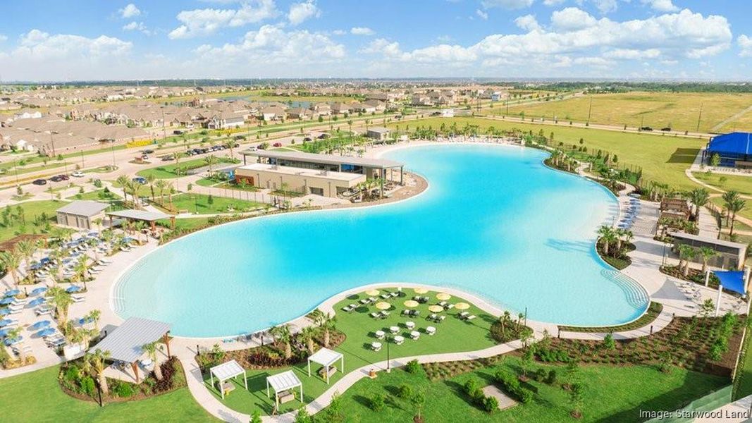 Stunning aerial view of Sunterra’s signature crystal lagoon, one of the community’s most sought-after resort-style amenities, offering a unique waterfront lifestyle right in Katy.