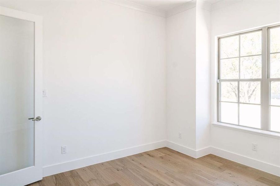 Unfurnished room featuring light wood-type flooring