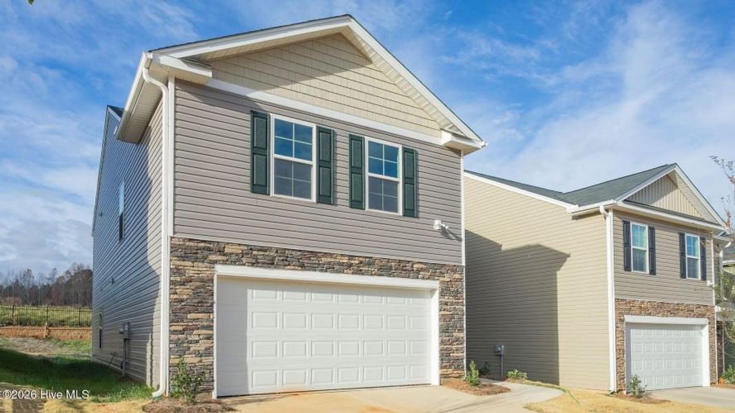 Front exterior of a new home in Carter Ridge, Greenville, NC, highlighting curb appeal (Image 2). Front exterior of a new home in Carter Ridge, Greenville, NC, highlighting curb appeal (Image 2).