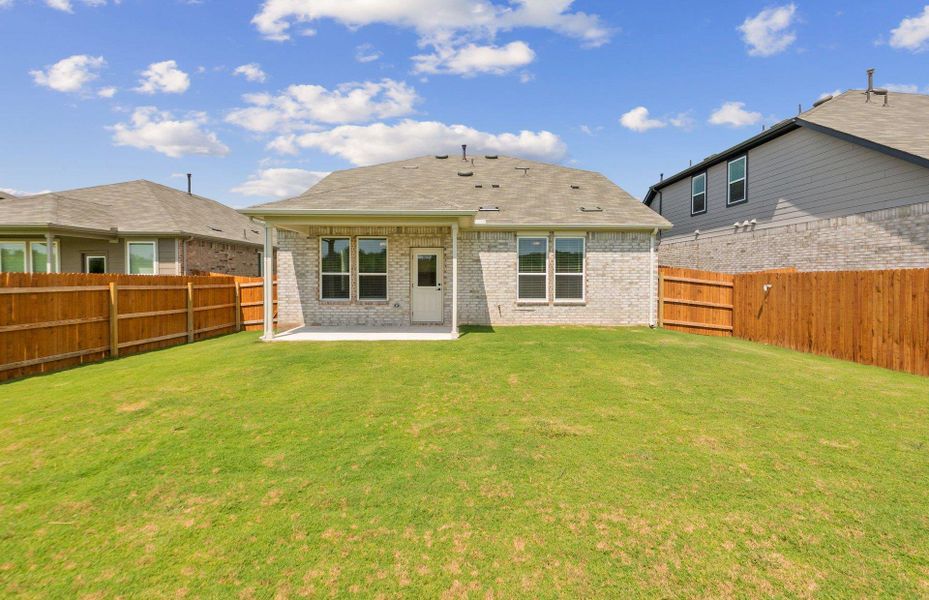 Back of property featuring a patio area, brick siding, a fenced backyard, and a shingled roof Back of property featuring a patio area, brick siding, a fenced backyard, and a shingled roof