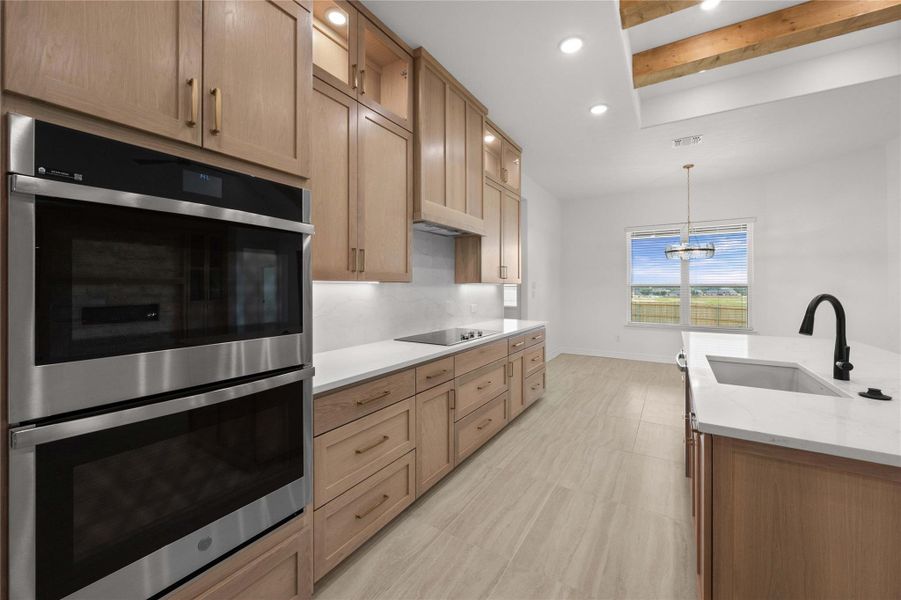 Culinary dreams come alive in this kitchen, featuring built-in appliances and an inviting kitchen island. Culinary dreams come alive in this kitchen, featuring built-in appliances and an inviting kitchen island.