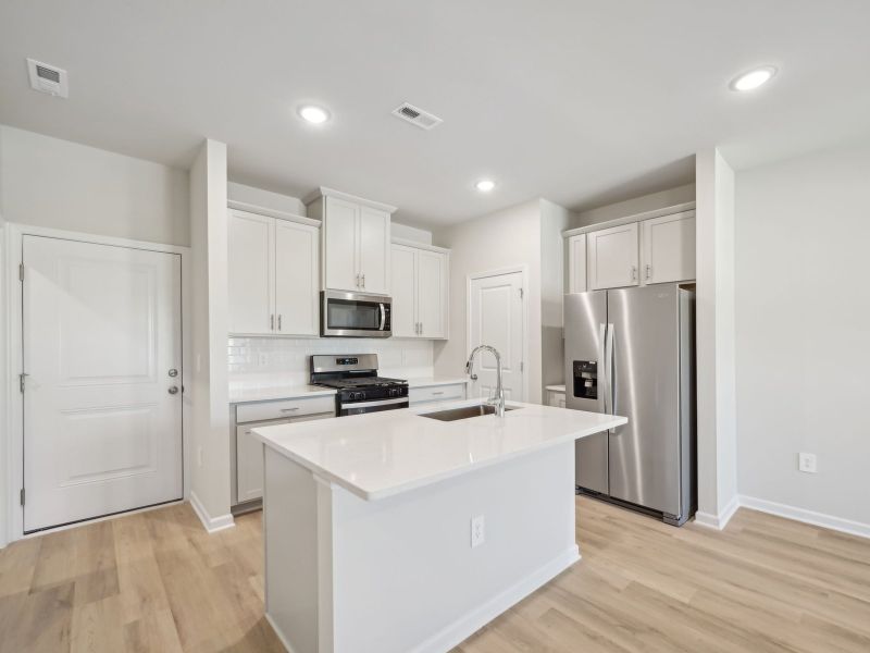 The spacious kitchen island is at the heart of the open-concept first floor.