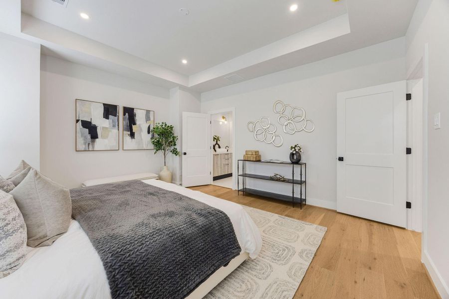 Primary bedroom with a spa-inspired ensuite bath and oversized walk-in closet.