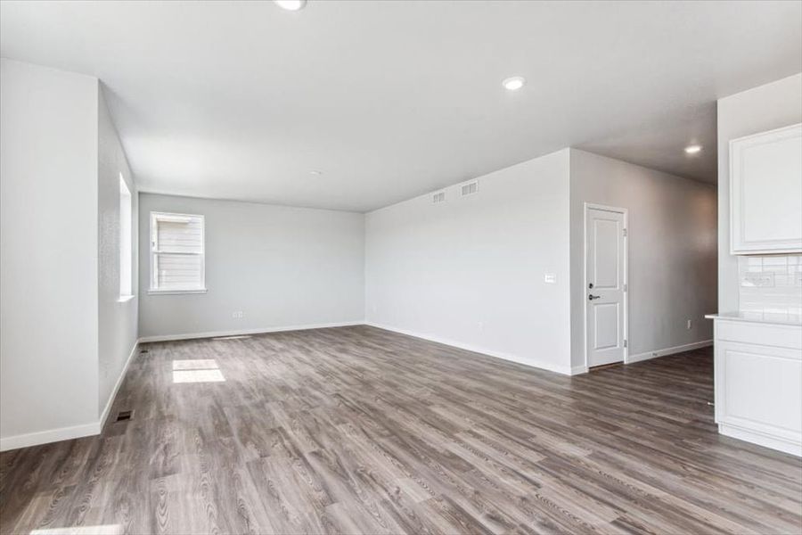 A room with a wood floor and white walls.