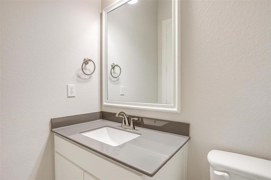 Bathroom featuring vanity and toilet