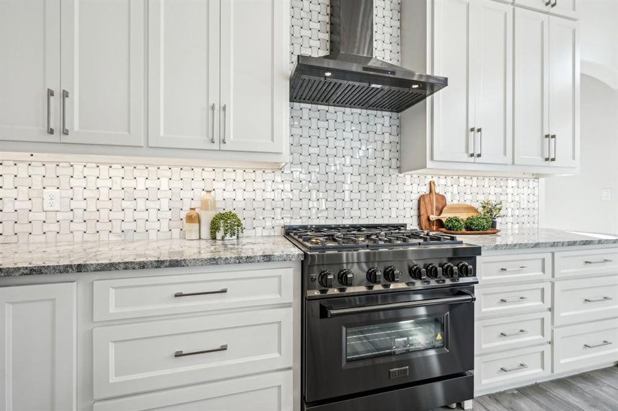 Luxury Z-line kitchen appliances in black stainless steel. Gas range and convection oven for gourmet meals.