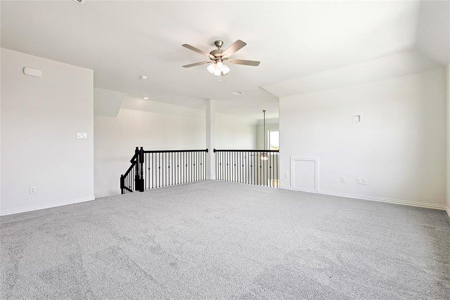 Spare room featuring carpet flooring and ceiling fan