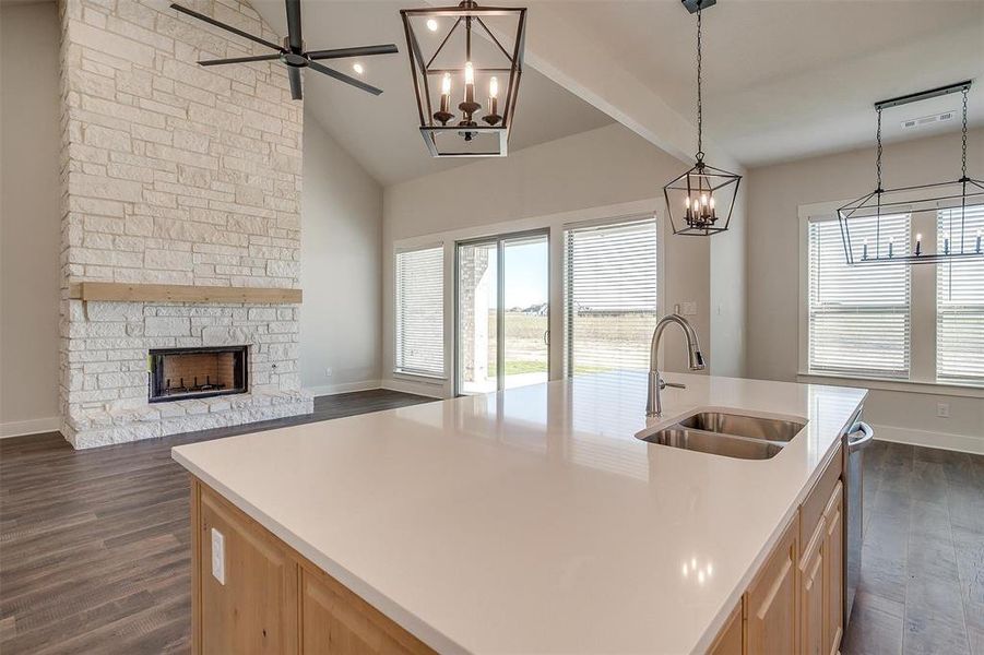 Kitchen with dark hardwood / wood-style flooring, sink, an island with sink, and light brown cabinets