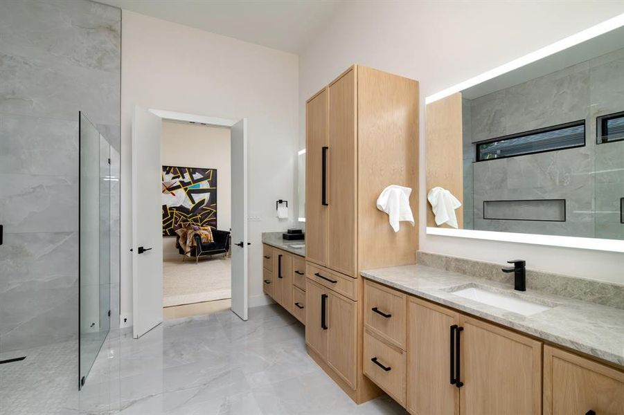 Bathroom featuring walk in shower, vanity, and tile floors