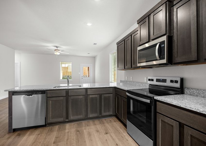 The kitchen has beautiful wood cabinetry.