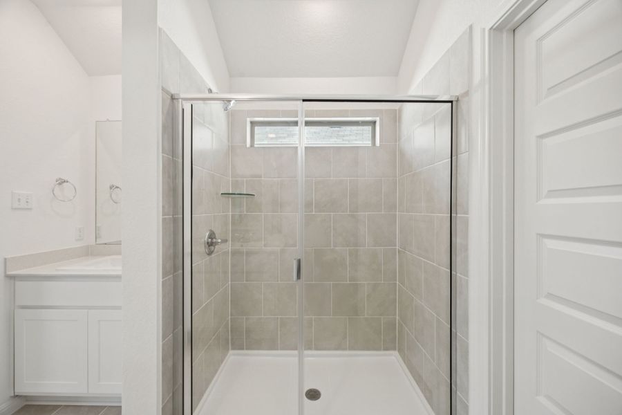 Primary Bathroom in the Redbud home plan by Trophy Signature Homes - REPRESENTATIVE PHOTO