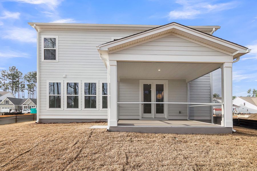 Exterior details and patio area of a home in Tidewater at Lakes of Cane Bay, Summerville (Image 24).