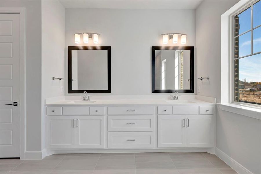 Full bath featuring double vanity and light tile patterned floors