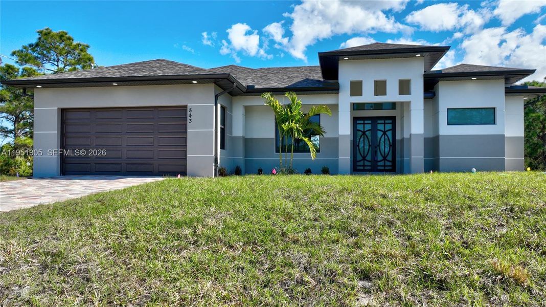 Front exterior of a new home in , Lehigh Acres, FL, highlighting curb appeal (Image 27). Front exterior of a new home in , Lehigh Acres, FL, highlighting curb appeal (Image 27).