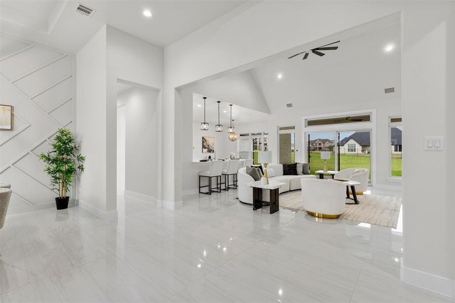 Living room featuring high vaulted ceiling