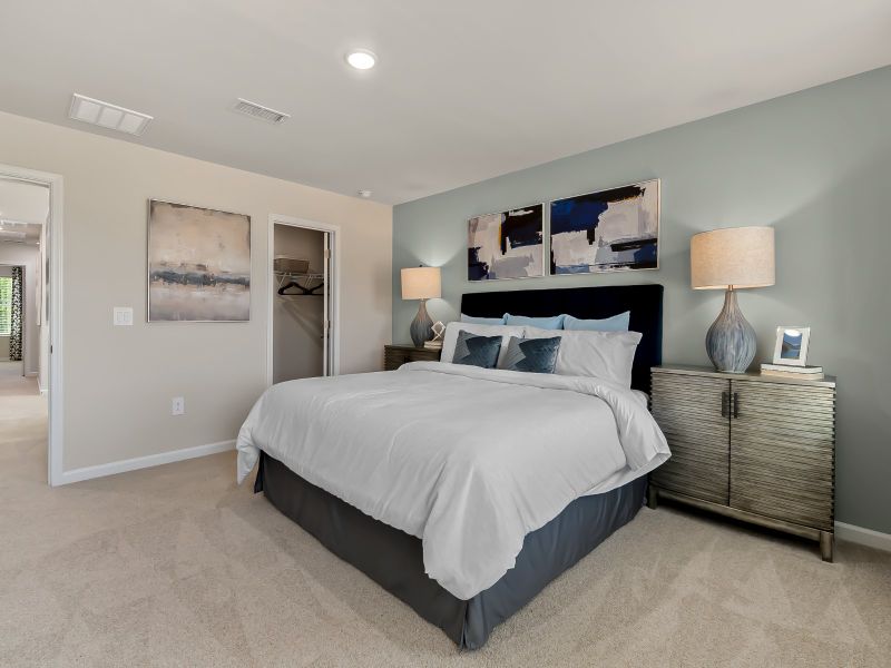 The large primary suite features an ensuite bath with dual sinks and a spacious walk-in closet.