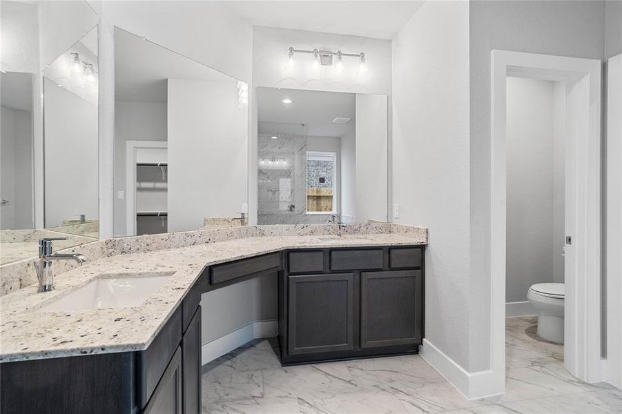 This large master bath is spacious enough to share! With separate vanities, large closet space, plentiful cabinet and counter space, you are sure to have private area while sharing this bathroom!