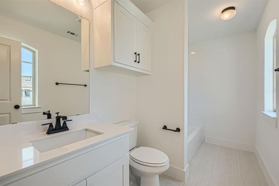 Full bathroom with  shower combination, vanity, and toilet