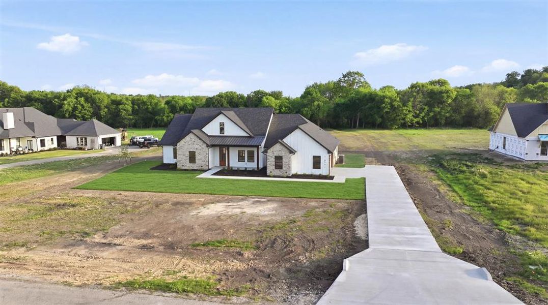 Front exterior of a new home in , Weatherford, TX, highlighting curb appeal (Image 19).