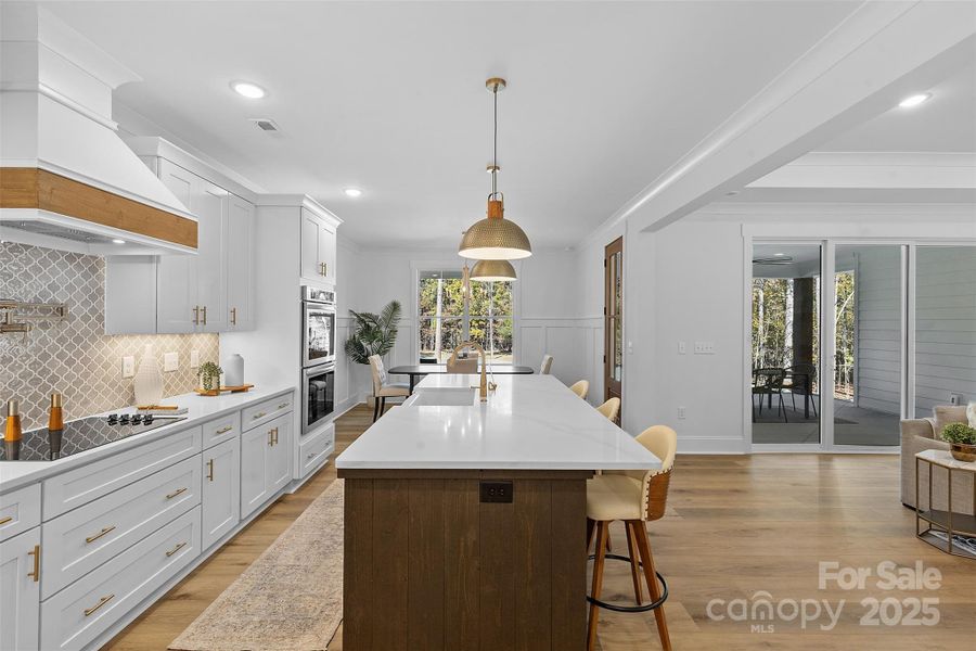 *representative photo- gourmet kitchen w/ custom wood hood vent, double oven, microwave built into the island, oversized level 3 quartz countertops, porcelain farmhouse sink