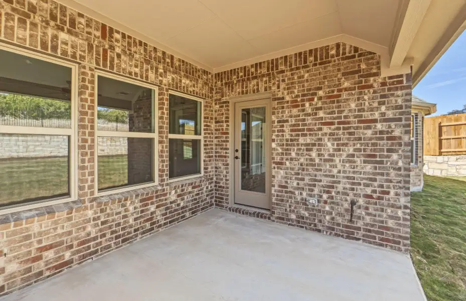 Exterior details and patio area of a home in West Cypress Hills, Spicewood (Image 19).