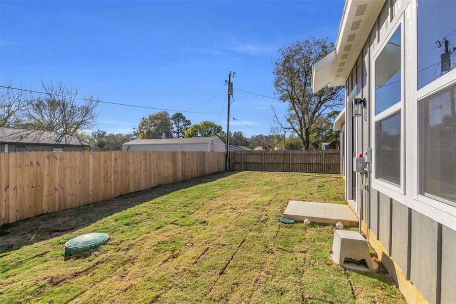 View of fenced backyard