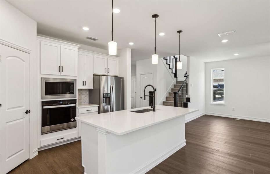 Spacious eat-in kitchen designed with a large island for dining *Real home pictured