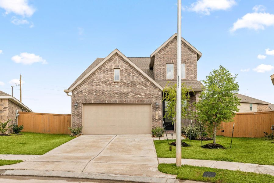 Front exterior of a new home in Sunterra, Katy, TX, highlighting curb appeal (Image 19).
