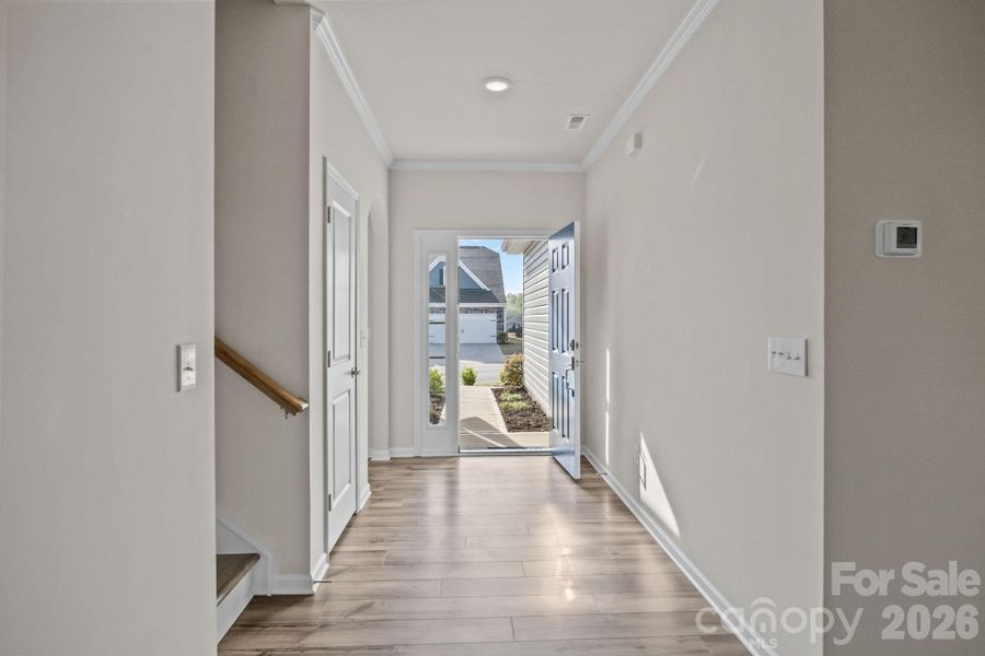 Entry Hallway with large closet and arched entry offset to Office/Bedroom #1 and Full Bath for privacy.