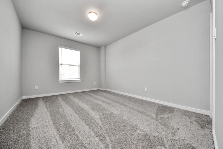 Secondary bedroom features plush carpeting, large windows that let in plenty of natural light, bright paint, and spacious closets. Secondary bedroom features plush carpeting, large windows that let in plenty of natural light, bright paint, and spacious closets.