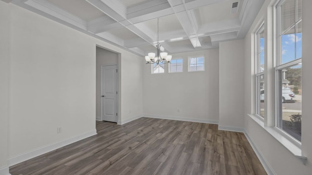 Fairfield design dining room with elevated coffered ceiling and large windows at Lakeside Glen by DRB Homes, York, SC.