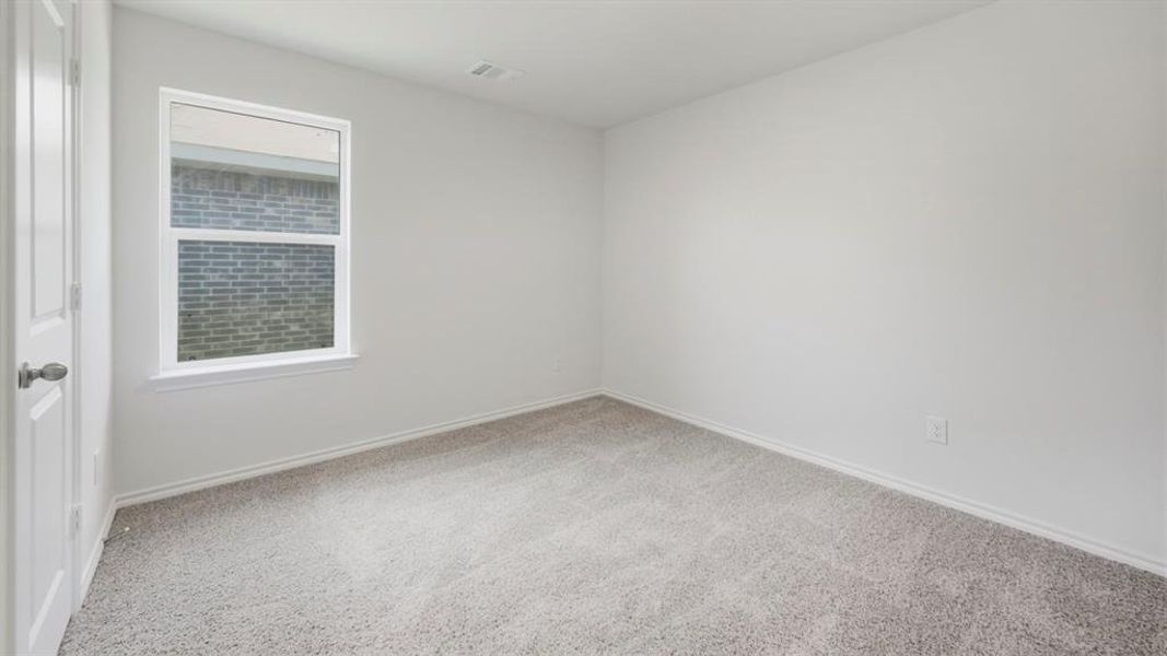 Empty room with light colored carpet and baseboards Empty room with light colored carpet and baseboards