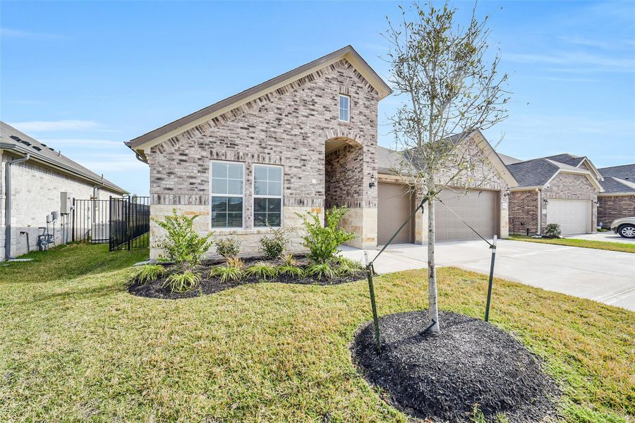 Front exterior of a new home in Sierra Vista, Rosharon, TX, highlighting curb appeal (Image 1). Front exterior of a new home in Sierra Vista, Rosharon, TX, highlighting curb appeal (Image 1).