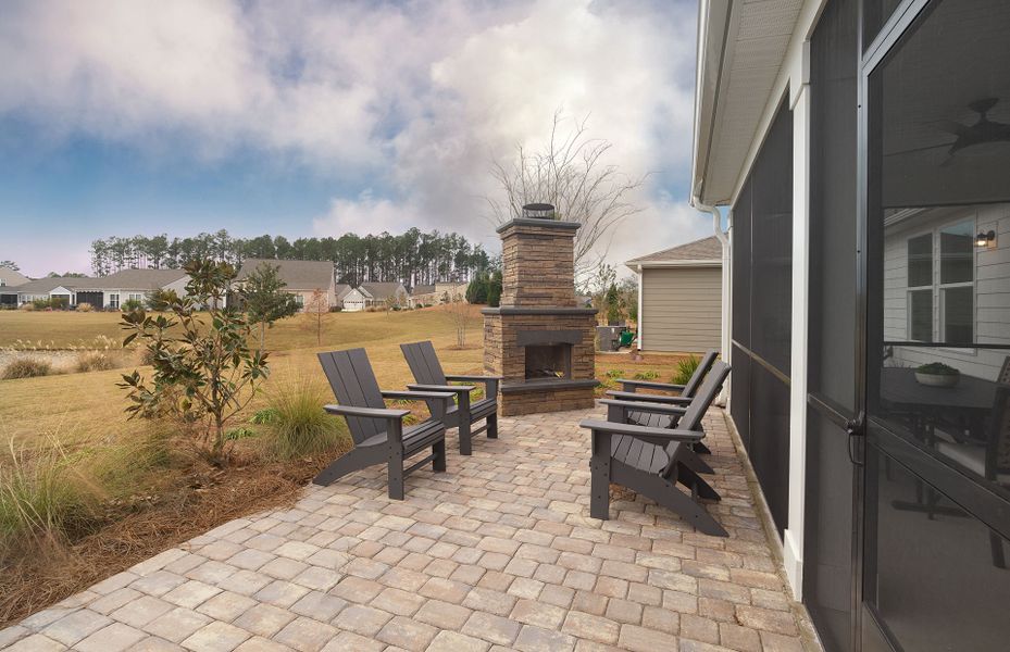 Embrace the backyard view of your new construction home as you relax on the patio.
