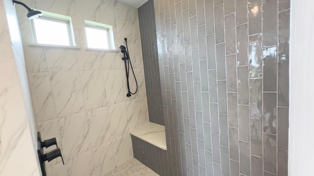 Full bath with a tile shower