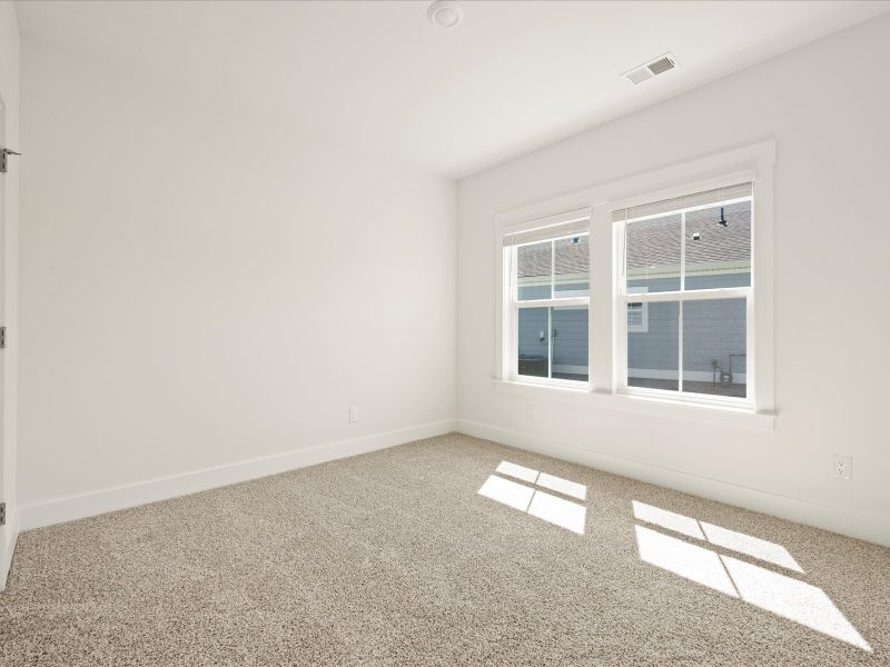 Spacious, unfurnished interior of a new home in The Coves at Lakes of Cane Bay, Summerville (Image 16).