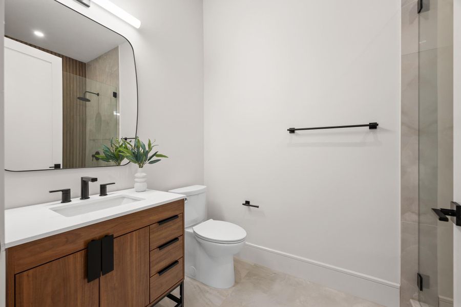 Clean lines and a floating wood vanity define this modern, minimalist powder room.