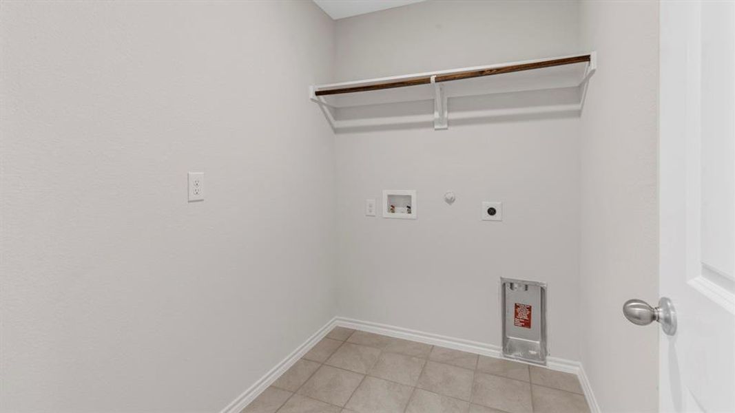Laundry room featuring gas dryer hookup, washer hookup, light tile patterned flooring, and hookup for an electric dryer