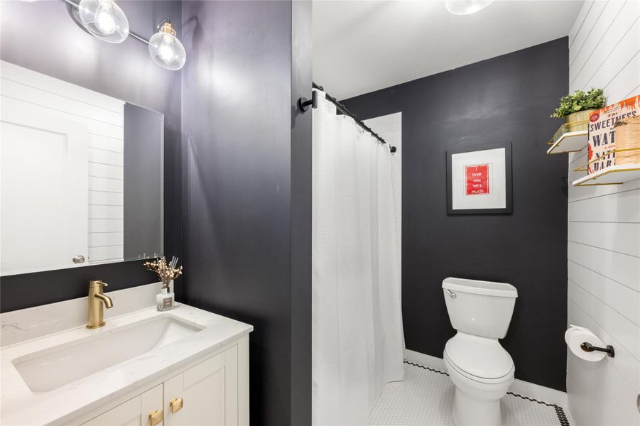 Modern fixtures elevate this compact bathroom with hexagon tile flooring and crisp white walls. Modern fixtures elevate this compact bathroom with hexagon tile flooring and crisp white walls.