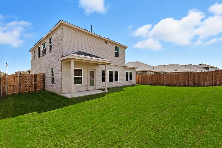 Back of house featuring a patio, a fenced backyard, and brick siding Back of house featuring a patio, a fenced backyard, and brick siding