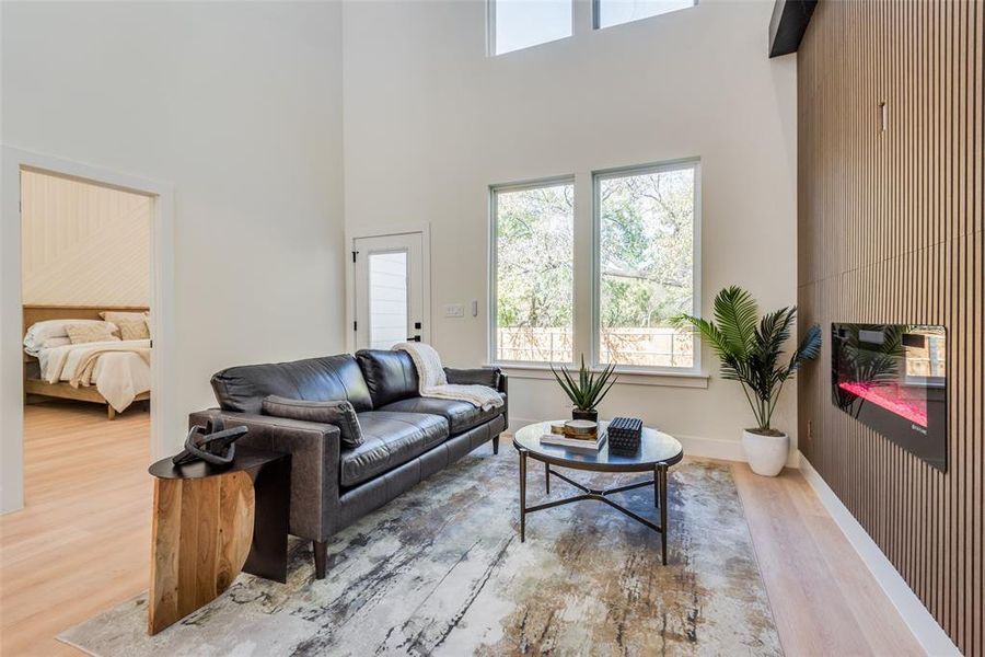 Living room featuring wood finished floors and a high ceiling