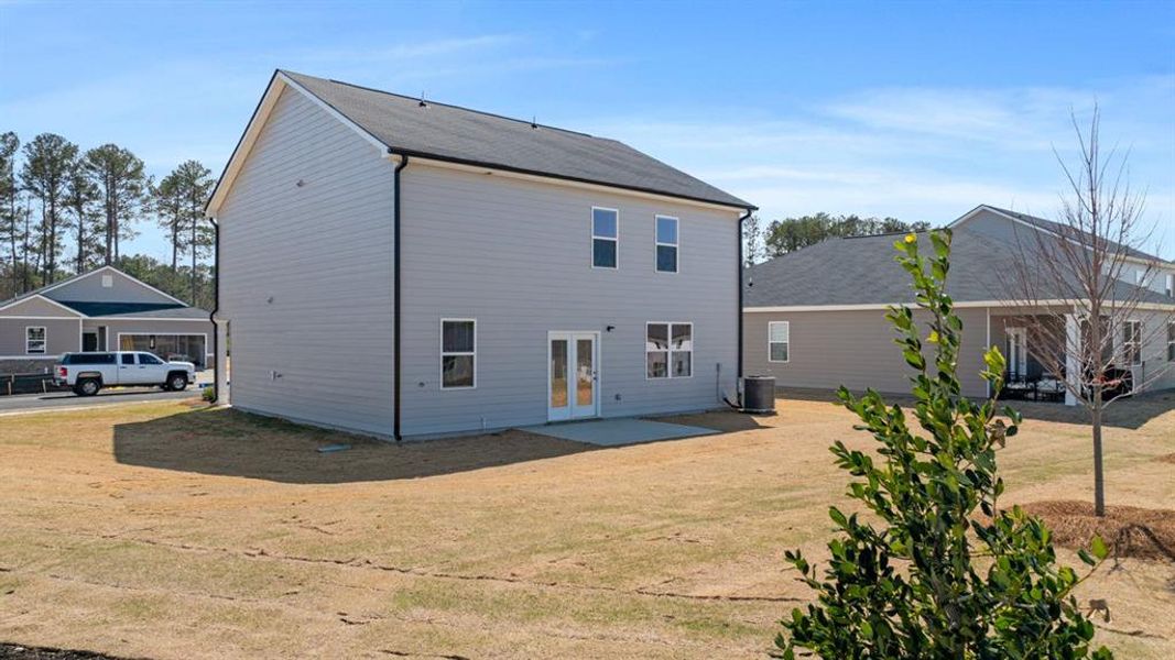 Front exterior of a new home in Champion's Run, Lithonia, GA, highlighting curb appeal (Image 21).