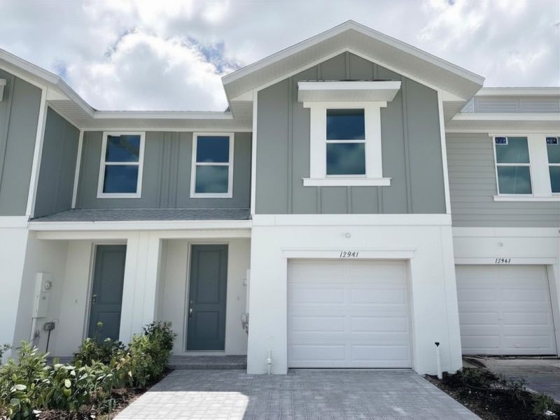 Front exterior of a new home in Meritage Homes at Central Park, Port St. Lucie, FL, highlighting curb appeal (Image 1). Front exterior of a new home in Meritage Homes at Central Park, Port St. Lucie, FL, highlighting curb appeal (Image 1).