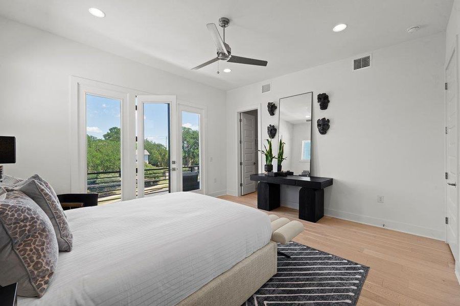 Spacious primary suite featuring floor-to-ceiling glass doors to your private balcony access.  Enjoy morning coffee with a view!