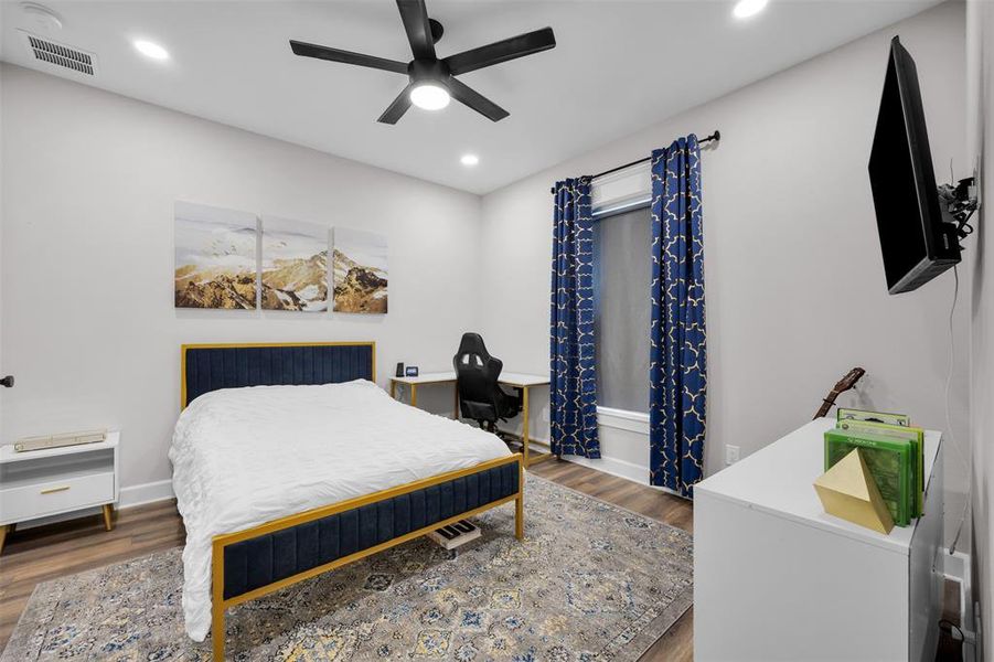 Bedroom featuring ceiling fan and dark hardwood / wood-style floors